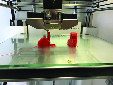 3D printer constructing models of buildings