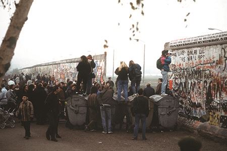 West German citizens gather at a newly created opening in the Berlin Wall