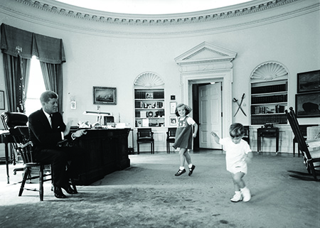 President John F. Kennedy and children play in Oval Office